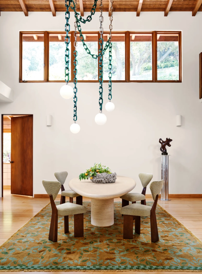Simple Dining Room with Small Table, Four Chairs, and Overhead Lights Hung by Green Chains