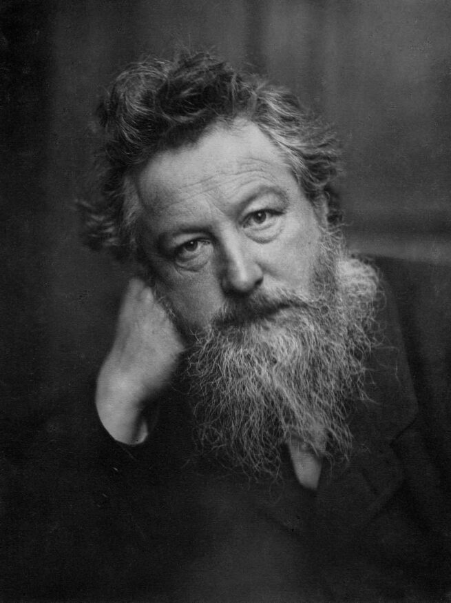 William Morris Rests his Head against Right Hand, Faces Camera