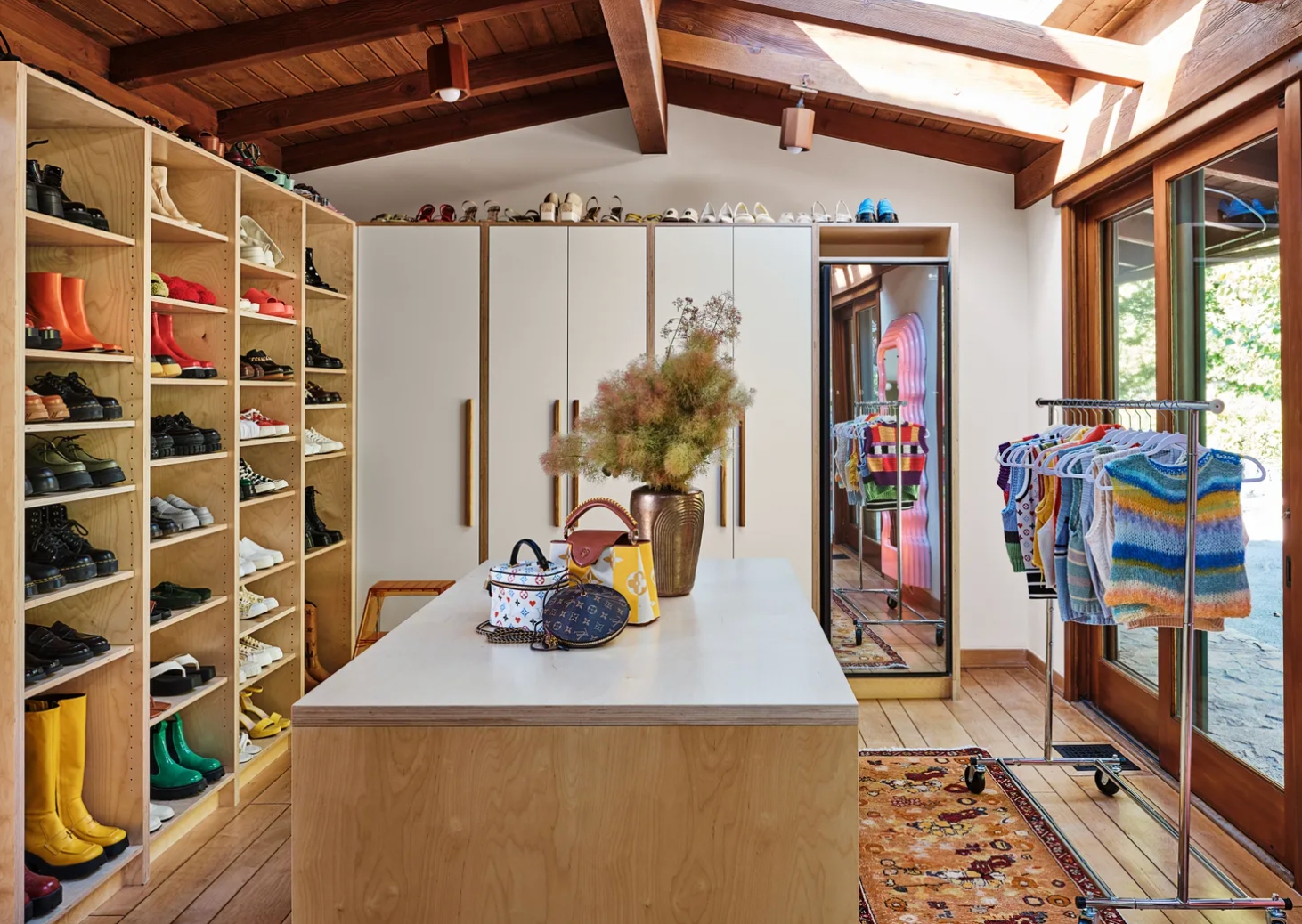 Walk-in Closet with Central Table, Shoes Shelves, and Hanging Sweaters