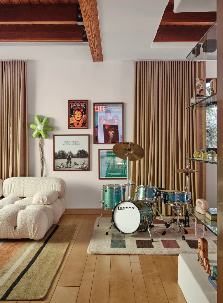 Living Room with Posters, Drum Set, and White Couch