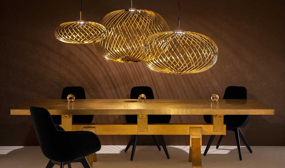 A trio of variously sized pendant lights brighten up an otherwise dim dining room