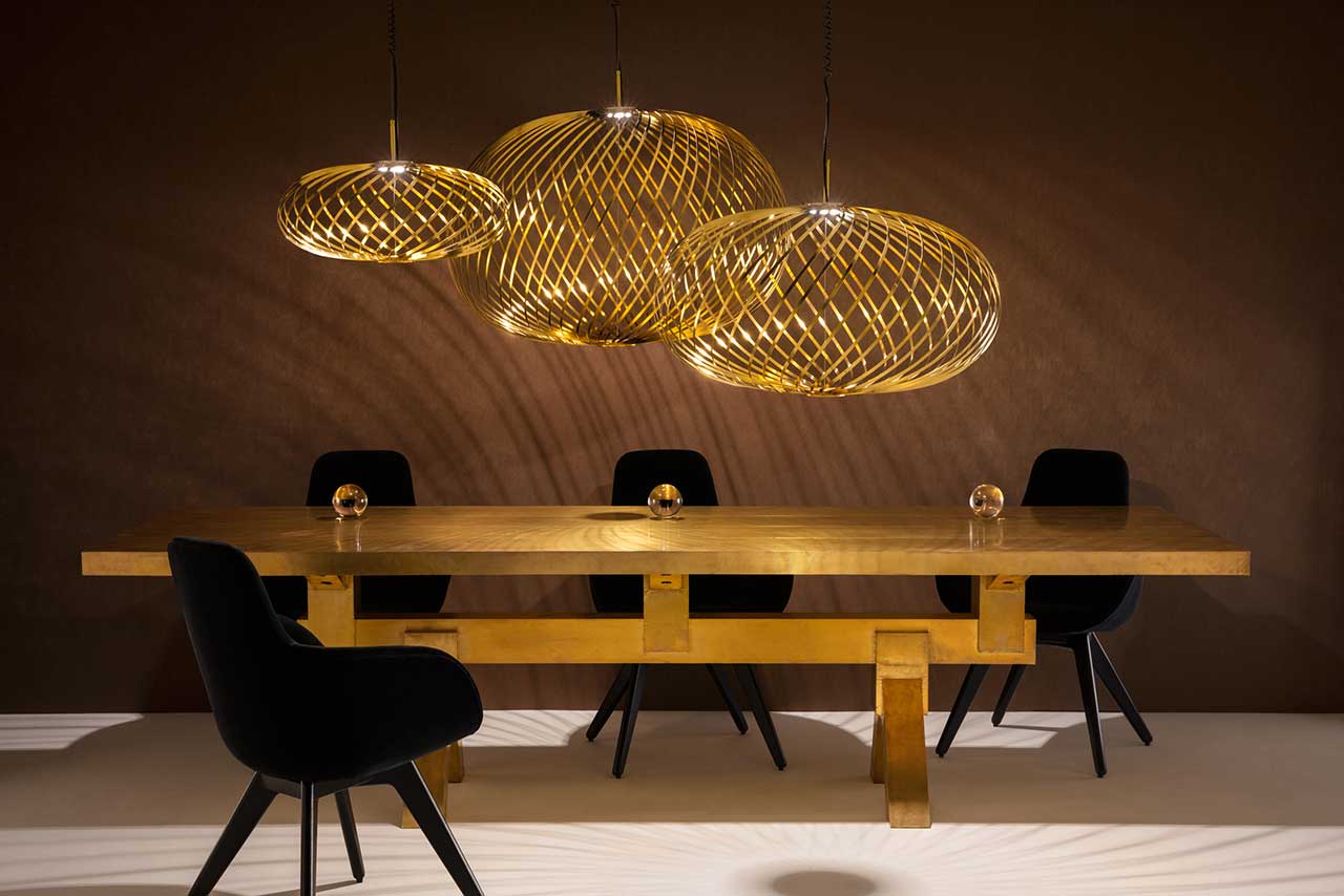 A trio of variously sized pendant lights brighten up an otherwise dim dining room