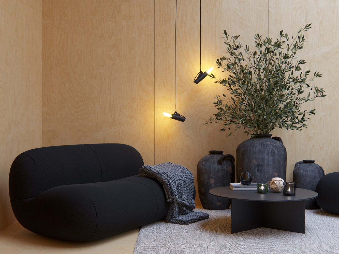 A black sofa and coffee table pop against a light wood wall behind them