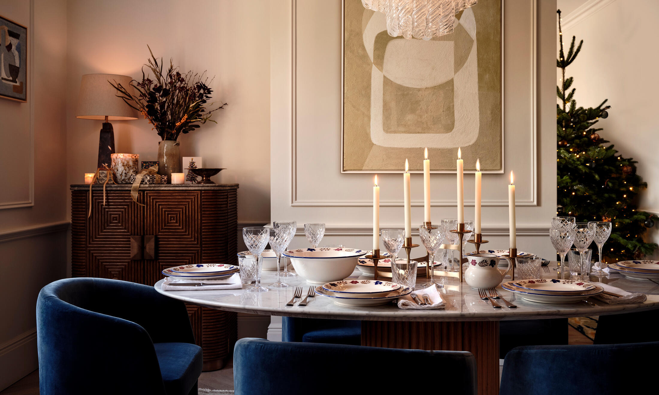 A dining set featuring a series of candles as a centerpiece